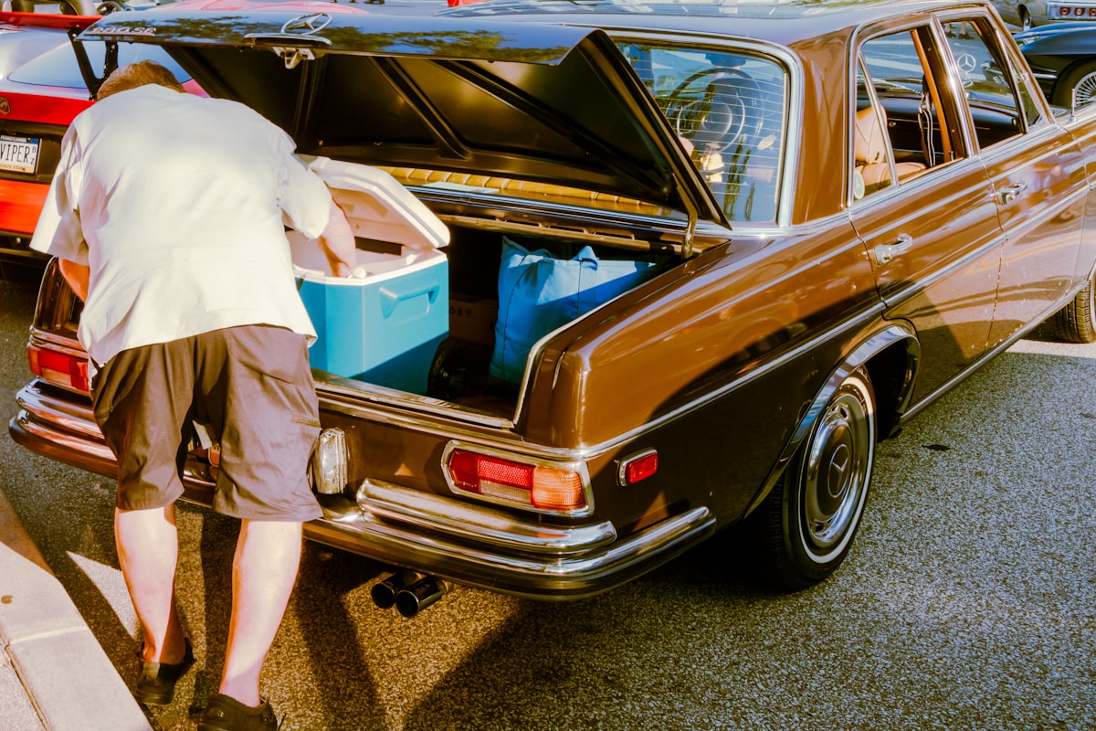 Removing items from a car trunk to clear it out before a mobile detail