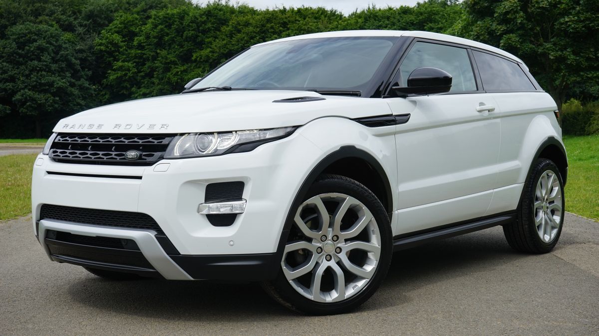A white Range Rover SUV with clean paintwork parked on a road.