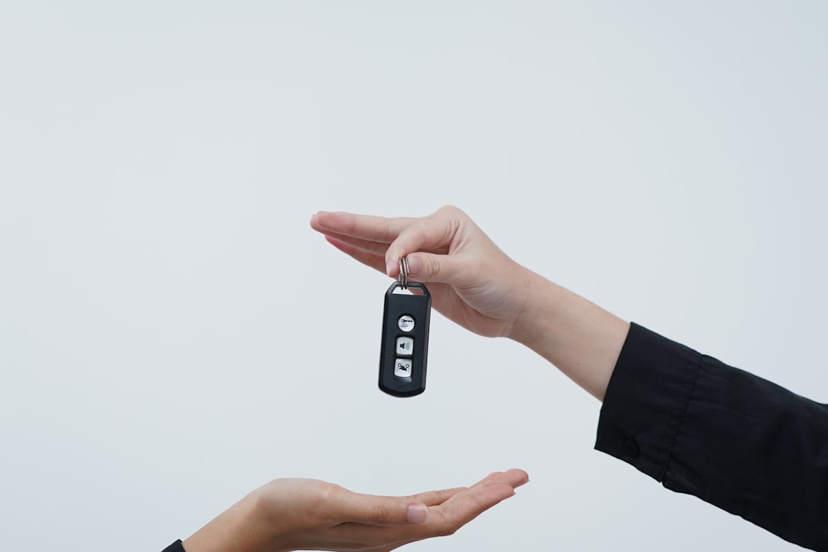 Handing over car keys after a sale — the moment a clean, well-presented car is supposed to make easier